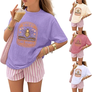 Detail view of retro bee print T-shirt and striped shorts set in multiple color options