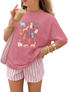 Detail of pink dog print t-shirt paired with striped shorts and pink bag in a studio shot