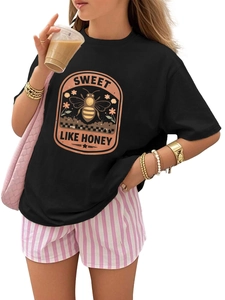 Detail of vintage honey bee print on a black crew neck T-shirt with stylish outfit pairing