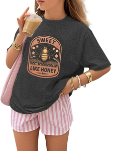 Close-up of charcoal grey vintage t-shirt with orange honeybee graphic and retro text
