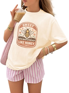 Detail of vintage honey bee print on a beige cotton crewneck t-shirt for kids
