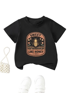 Flat lay of black cotton kids T-shirt with vintage Sweet Like Honey print and accessories