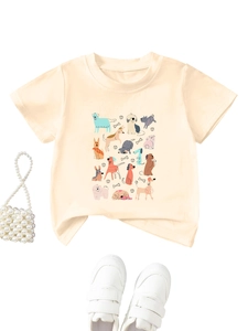 Detail of kids cotton T-shirt featuring cartoon dogs with bone and ball pattern print