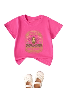 Flat lay of pink kids t-shirt with bee print and white lace bow baby shoes