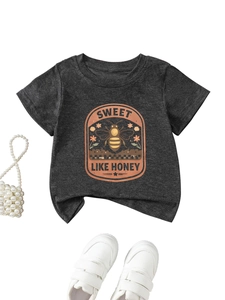 Detail of kids vintage honeybee print T-shirt with pearl bag and white sneakers