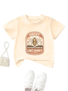 Detail of soft cream cotton kids T-shirt featuring vintage bee print and accessories