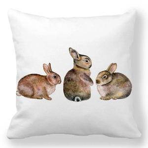 Detailed close-up of three watercolor rabbits on a soft white peach skin pillowcase