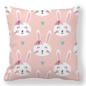 Detail of pink Easter cushion cover featuring cute bunny pattern and floral motifs