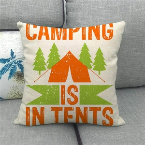 Detail of square linen cushion cover featuring camping tent and pine tree prints