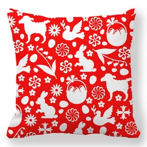 Detail of red Easter cushion cover with white rabbit and egg silhouette patterns