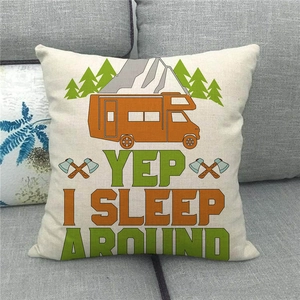Linen camping pillow cover with 'Yep I Sleep Around' camper van print on grey sofa