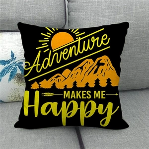Detail view of the Adventure Makes Me Happy decorative linen pillow on a grey sofa