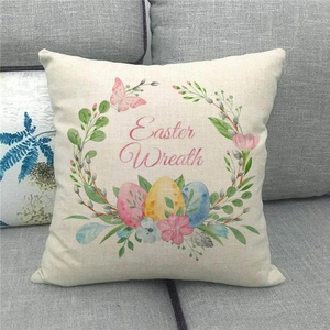Easter Wreath linen pillow cover with watercolor floral eggs on a cozy sofa