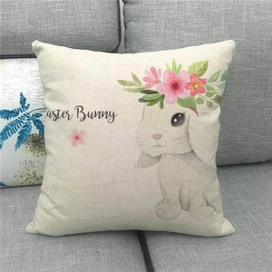 Close-up of Easter Bunny watercolor print on textured linen pillowcase on a sofa