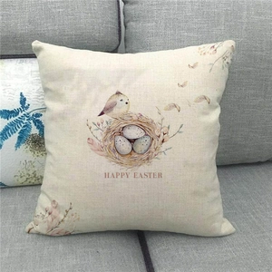 Detail of linen Easter pillow cover with bird nest design and Happy Easter text