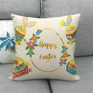 Close-up of Happy Easter linen pillowcase with colorful rabbits and eggs on a grey sofa
