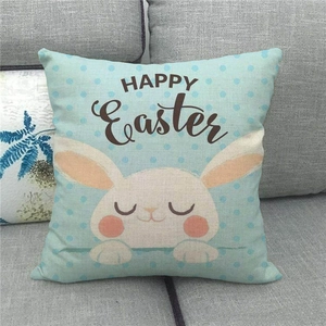 Happy Easter linen pillowcase with cute bunny and blue polka dots on a sofa