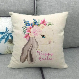 Detail of Happy Easter linen pillowcase showing bunny print and fabric texture on sofa