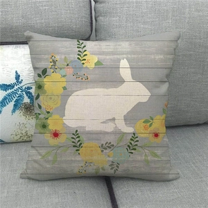 Detail of Easter linen pillowcase showing white rabbit silhouette and floral wood texture