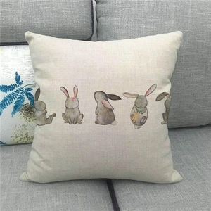 Detailed texture of linen pillowcase featuring five watercolor Easter bunny illustrations