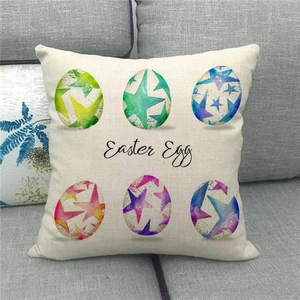 Detail of linen Easter cushion cover with colorful eggs and starry textures on a sofa