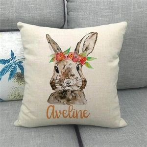 Close-up of linen Easter cushion with watercolor bunny and personalized Aveline text