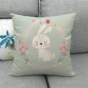 Linen Easter pillow cover detail with cute bunny and floral wreath on sofa