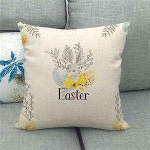 Detail of linen Easter pillowcase featuring a rabbit and colorful eggs on a grey sofa