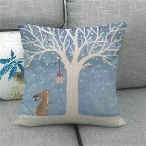 Linen pillowcase featuring an Easter rabbit illustration on a modern gray fabric sofa