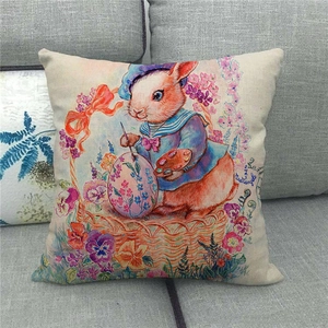 Linen Easter pillow cover featuring a painter rabbit with eggs on a cozy gray sofa