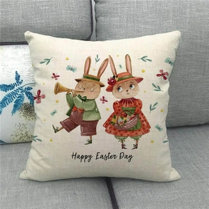 Close-up of Easter linen pillowcase with bunny illustration on a grey sofa