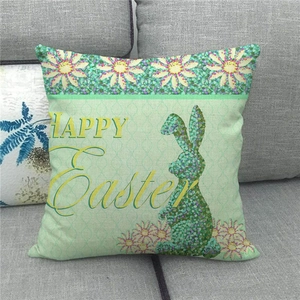 Detail of linen Easter pillow cover with Happy Easter bunny silhouette and daisy patterns