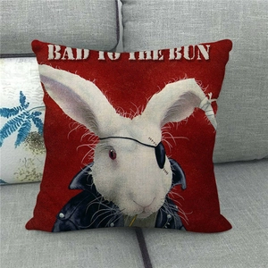 Detail of red punk bunny cushion cover with leather jacket on a grey fabric sofa