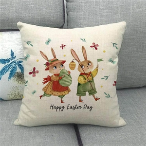 Detailed view of linen pillowcase with Happy Easter bunny print on a grey sofa