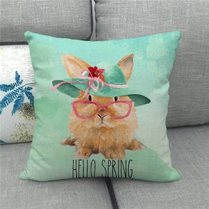 Linen Easter pillowcase with watercolor rabbit and Hello Spring text on a grey sofa