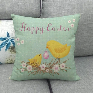 Detail of linen Easter pillow cover with chicks and Happy Easter text on gray sofa