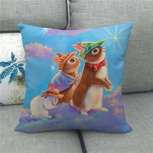 Linen pillowcase with cute Easter rabbits illustration on a cozy grey fabric sofa