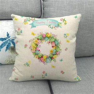 Close-up of Happy Easter linen pillowcase with colorful egg patterns on a gray sofa