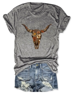 Detail of floral cow skull graphic on grey T-shirt with distressed denim shorts