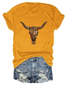 Detail of ginger yellow t-shirt with floral bull skull print and ripped denim shorts