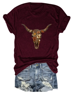 Detail of floral bull skull graphic on a burgundy round neck t-shirt with denim shorts
