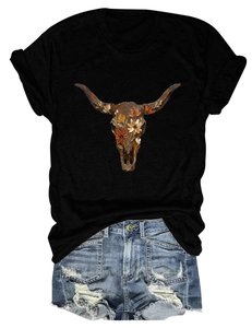 Flat lay of black bull skull t-shirt with floral print and distressed denim shorts