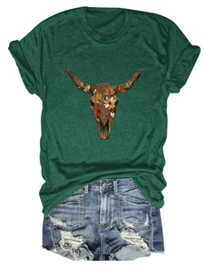 Detail of floral cow skull print on green t-shirt with distressed denim shorts
