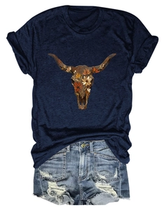 Flat lay of navy bull skull t-shirt with floral print and distressed denim shorts