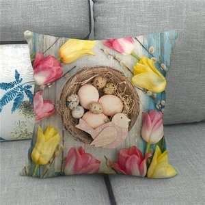 Linen Easter pillow cover with bird nest and tulips on vintage blue wood texture