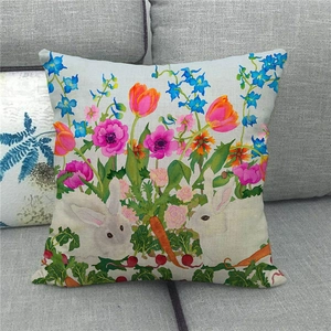 Detailed view of linen Easter pillow cover with rabbit and floral garden print on grey sofa