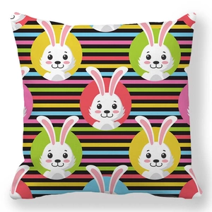 Detailed view of square pillowcase with colorful stripes and cartoon bunny prints