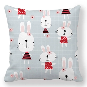 Close-up of Easter cushion cover with cute white rabbits and blue checkered background
