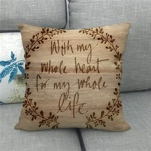 Close-up of linen cushion with wood grain print and romantic English quote