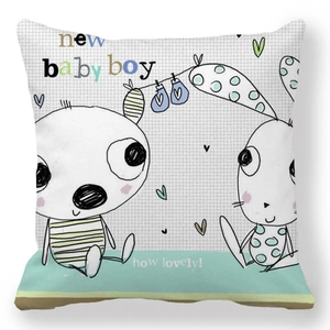 Detail of soft peach skin cushion cover featuring hand-drawn bunny and new baby boy text
